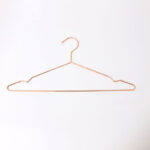 Metal shirt hanger with notches for retail display
